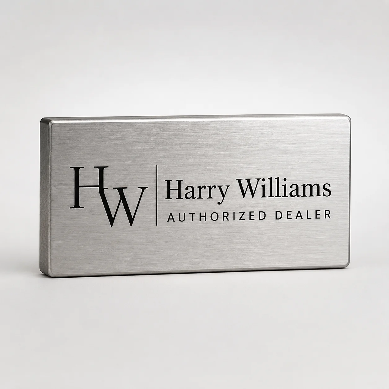 Brushed metal logo block with etched black-filled logo
