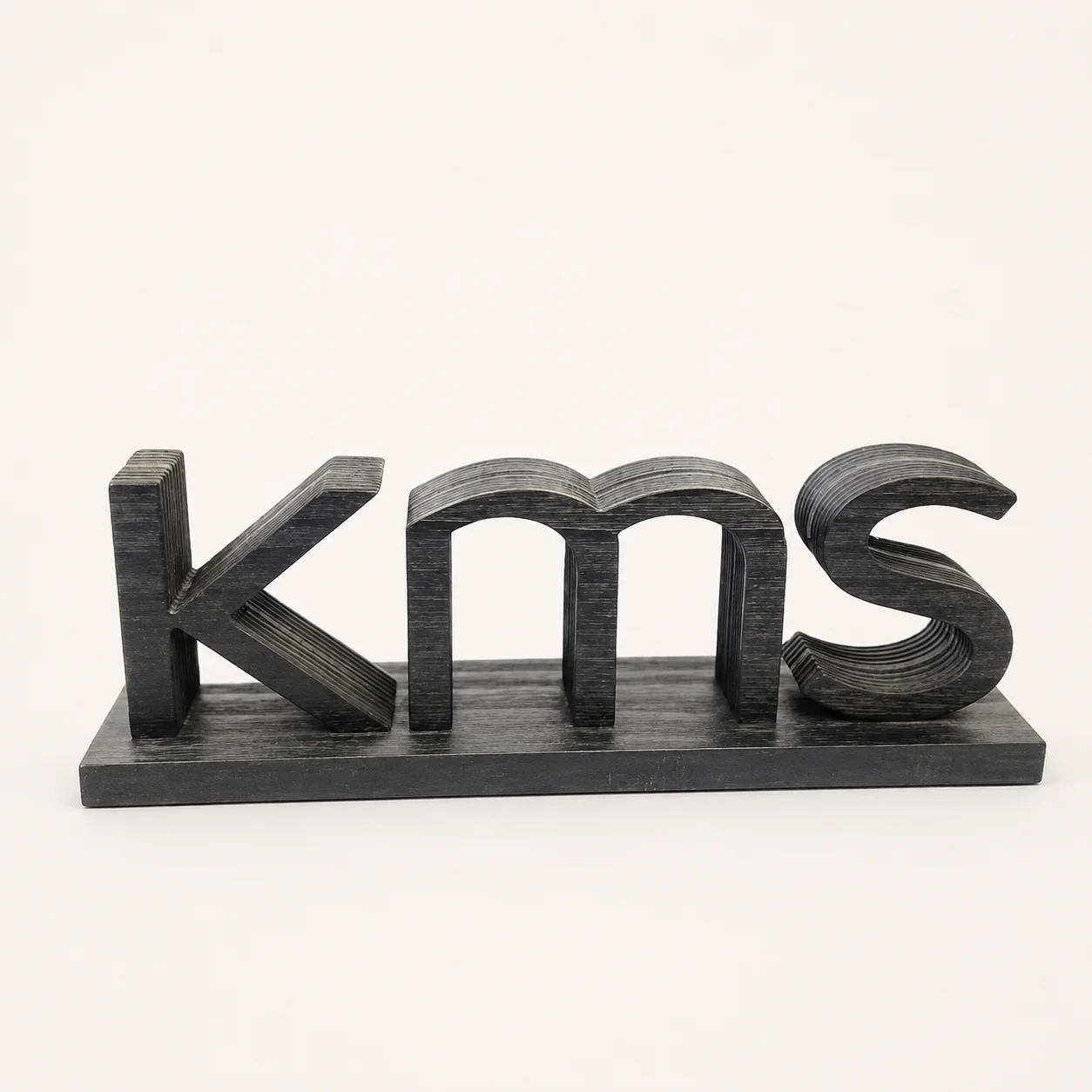 Three custom wooden letter logo blocks with special surface finishes