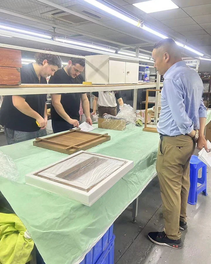 Visiting clients checking custom display dimensions and construction on the DNY factory floor