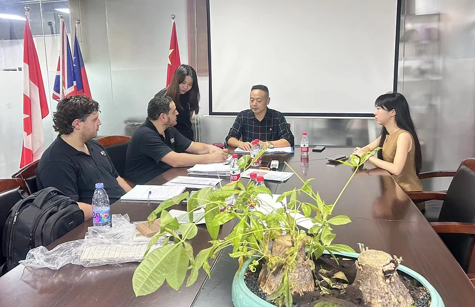 DNY team reviewing project drawings, materials and specifications face to face with visiting clients