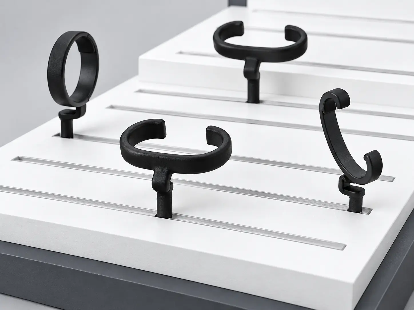 Adjustable C-ring watch holders installed in aluminum display channels
