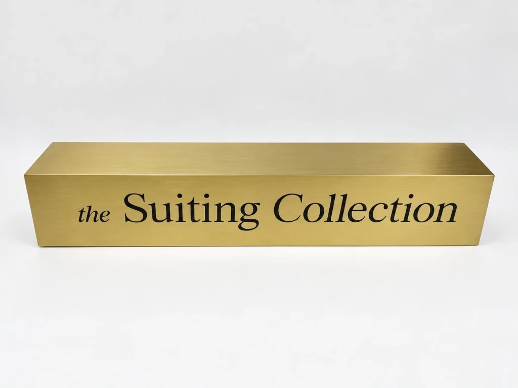 Custom Freestanding Metal Logo Sign with Brushed Gold Finish – custom retail display product by DNY DISPLAY